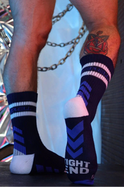 Person wearing striped socks with a colorful background